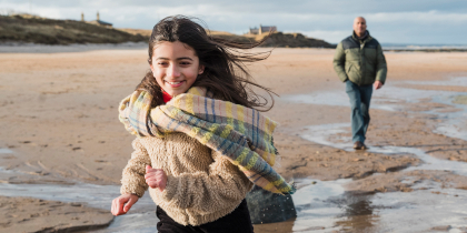 Happy girl running on beach