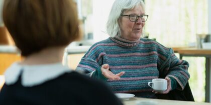 Two older people having a chat and a cup of tea