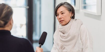 Photo of awoman being interviewed for the media
