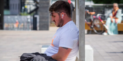 A man sitting in the shade on a hot day
